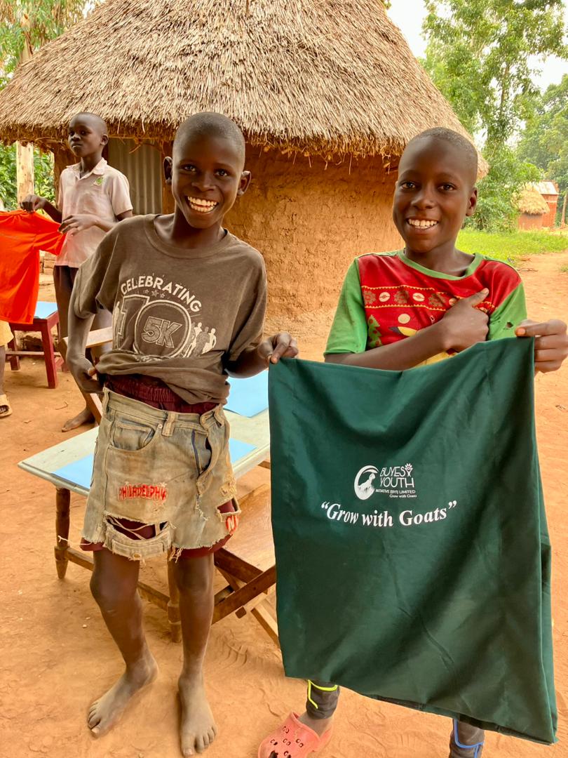 Children holding Grow with Goats banner