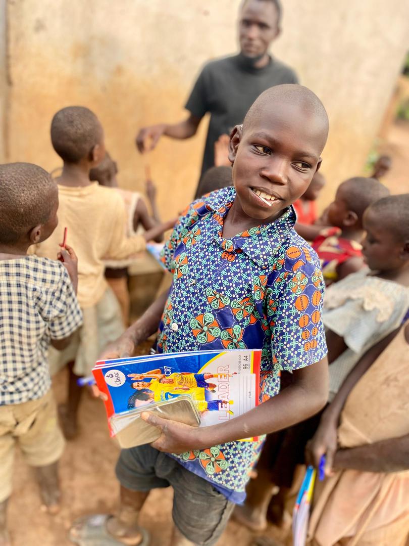 Child smiling with school books